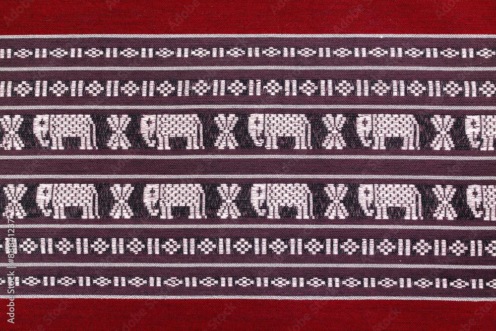   Texture of red cotton fabric, with white woven fabric elephant
