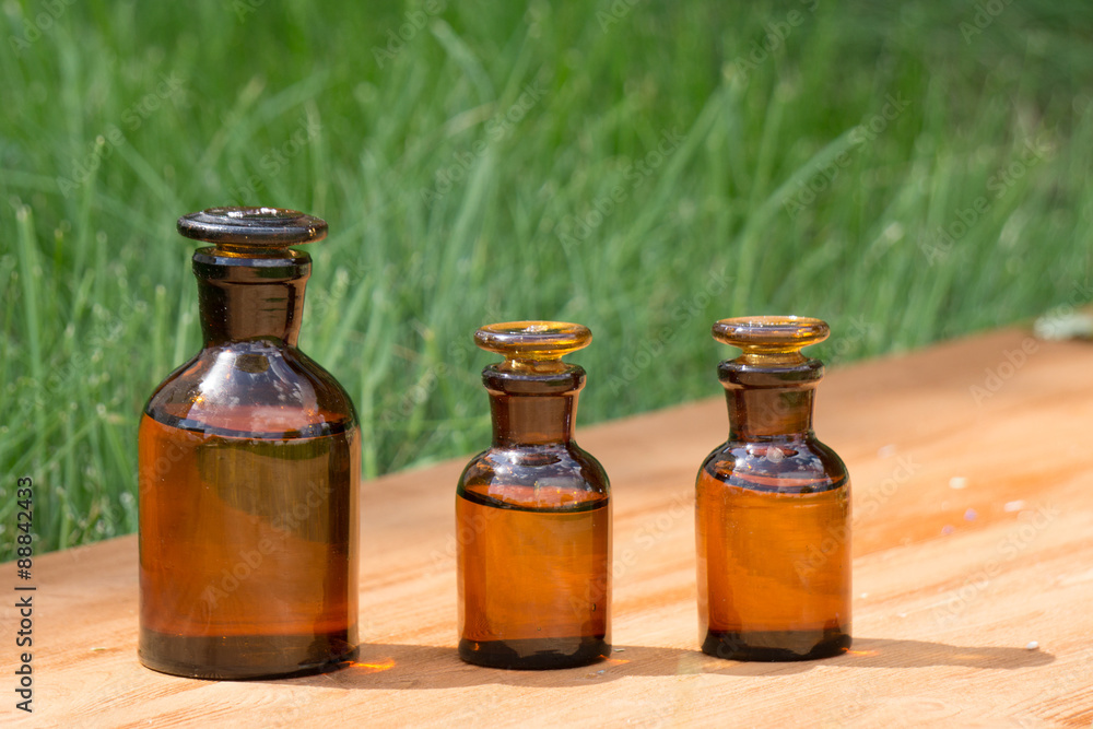little brown bottles on booden board and grass little brown bottles on booden board and grass