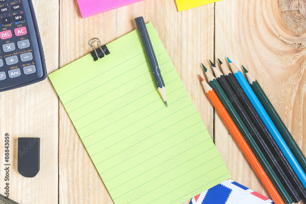 Notebook paper and school or office tools on wood table for back Notebook paper and school or office tools on wood table for back