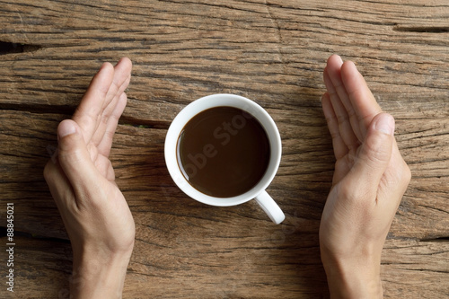 holding cup of coffee