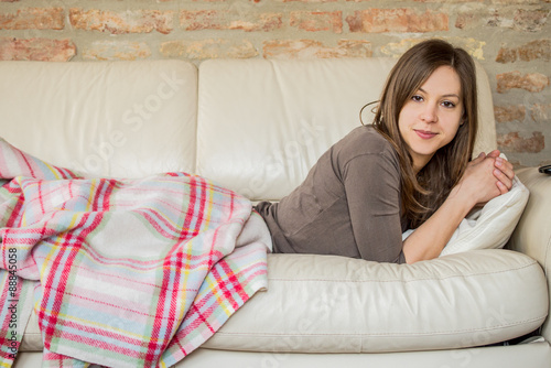 Serious woman laying in bed after wake up