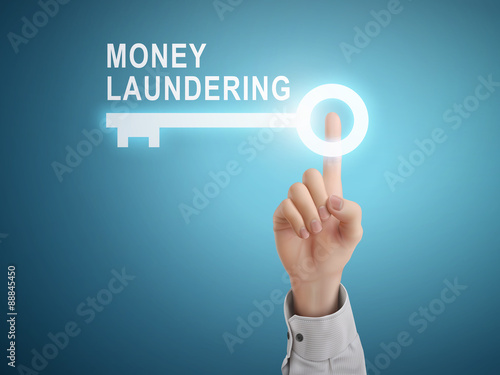male hand pressing money laundering key button