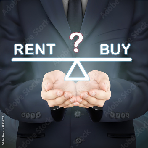 businessman holding rent and buy seesaw