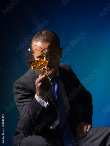 A man with a glass of cognac