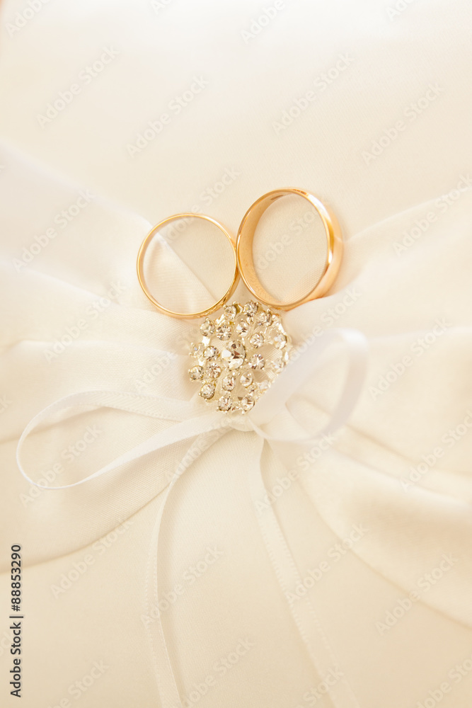 Gold wedding rings on a pillow. Gold wedding rings on a pillow.