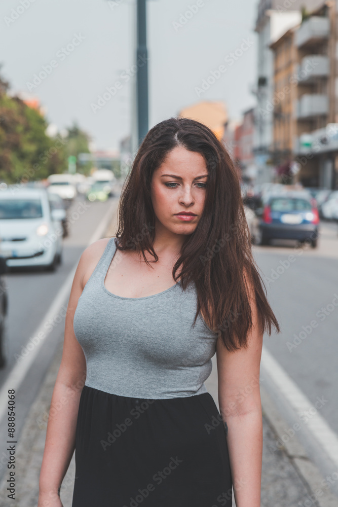 Beautiful curvy girl posing in an urban context Stock Photo