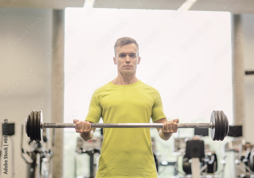 man doing exercise with barbell in gym man doing exercise with barbell in gym