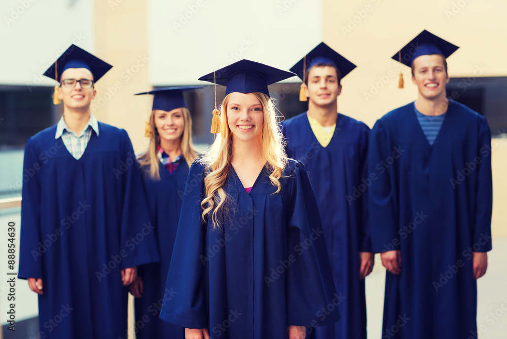 group of smiling students in mortarboards group of smiling students in mortarboards