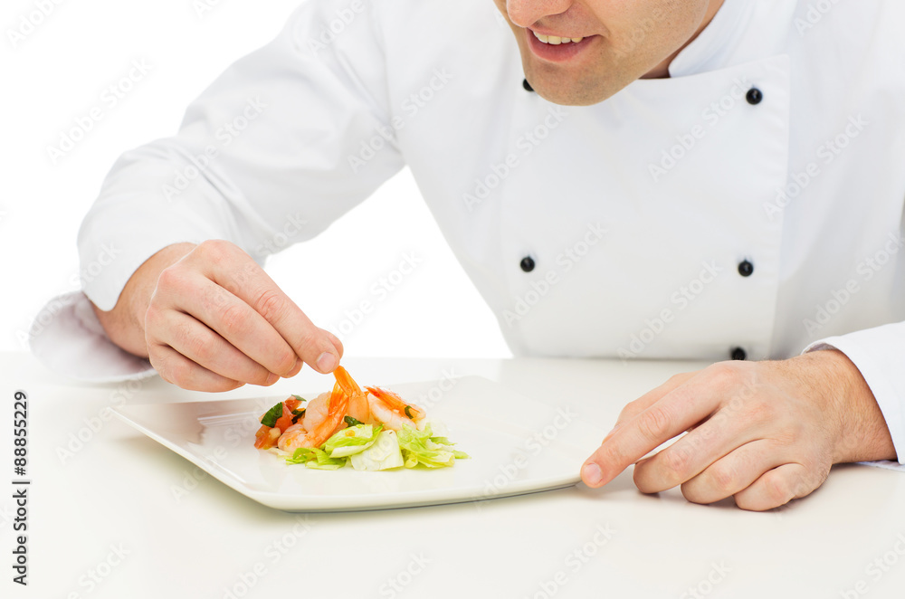 close up of happy male chef cook decorating dish close up of happy male chef cook decorating dish