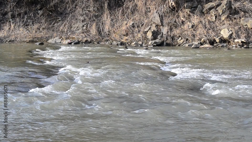 Mountain river with rapids and water flowing along river bank Mountain river with rapids and water flowing along river bank