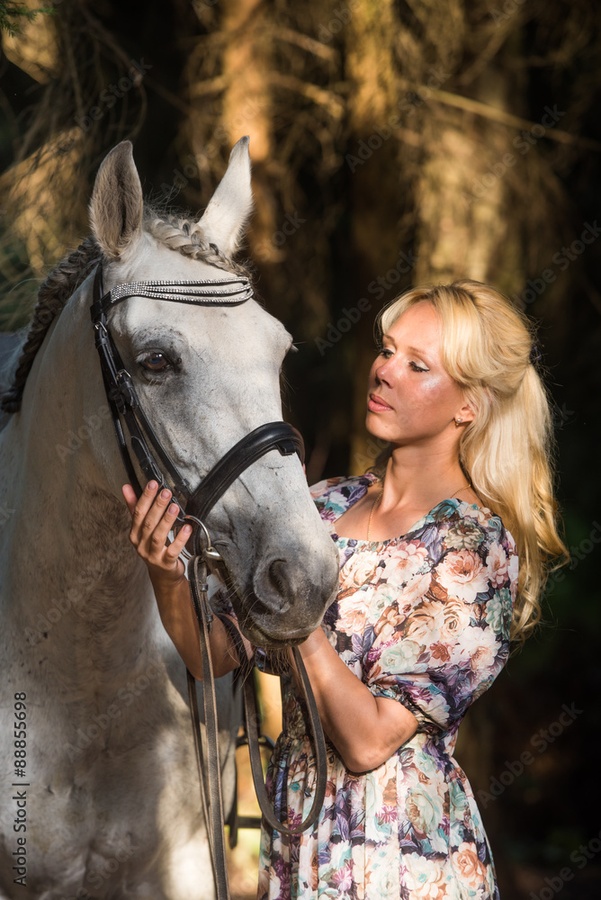 Obraz premium Beautiful blonde woman with a horse