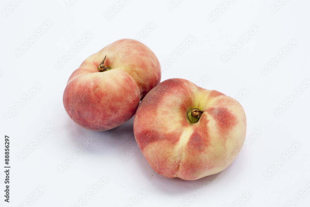 Ripe flat Chinese peaches on the white isolatd background Ripe flat Chinese peaches on the white isolatd background