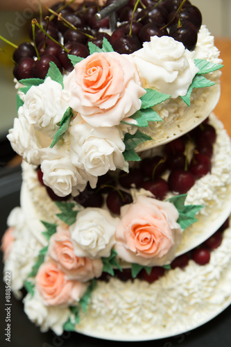 Tasty wedding cake with roses.