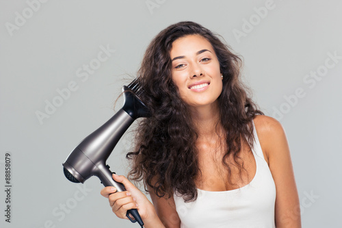 Portrait of a happy cute woman dries her hair