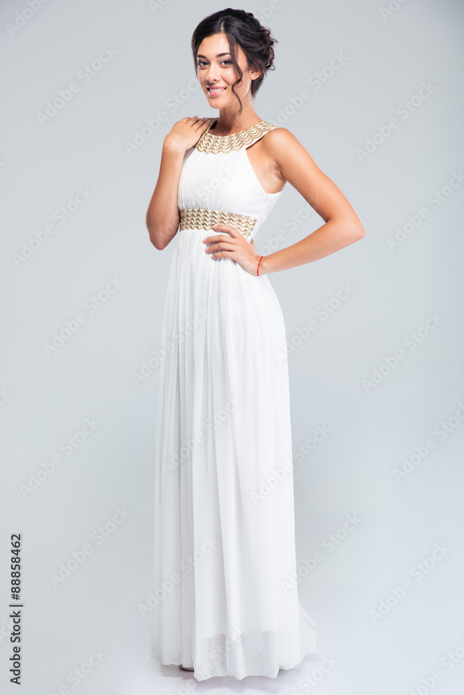 Cheerful cute woman standing in white dress Cheerful cute woman standing in white dress