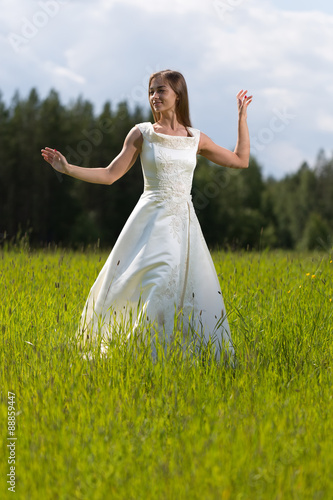 young girl in a wedding dress dancing