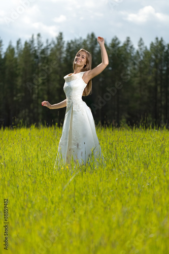 young girl in a wedding dress smiling and dancing