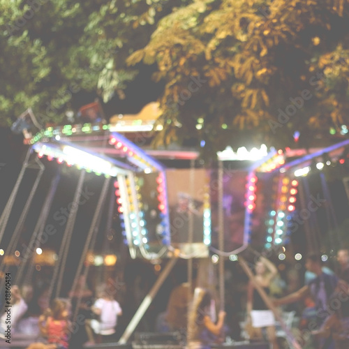 Colorful carousel in the night - defocused background.