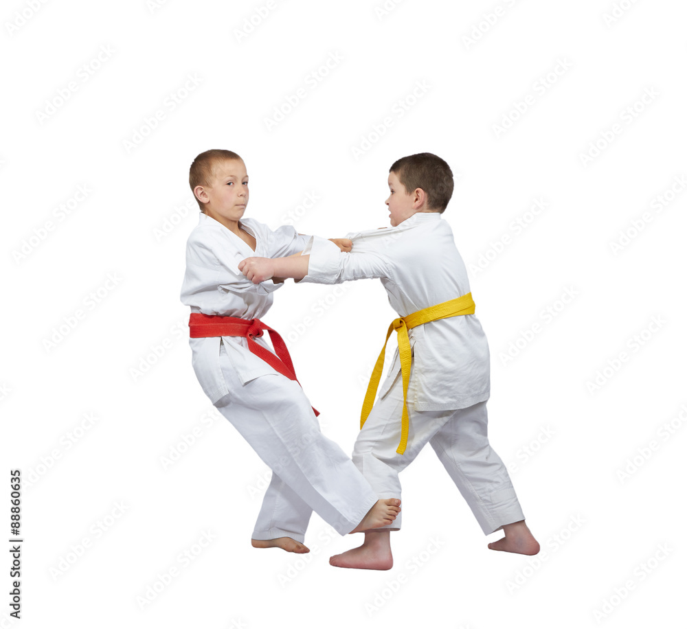 Boy with red belt makes slicing down under foot