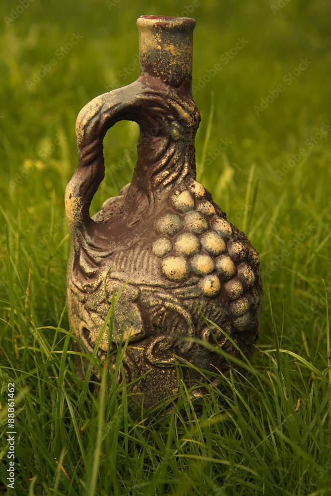 Fototapeta premium Clay pitcher on the lawn.