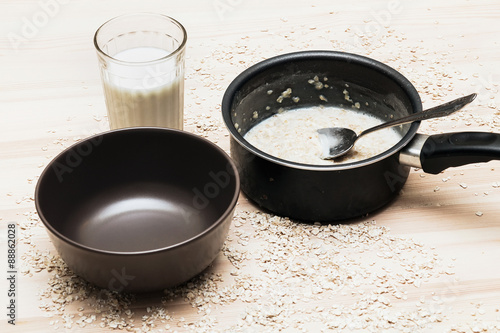 Empty bowl, pot of oatmeal 