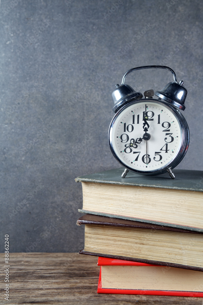 Back to school background with books and alarm clock Back to school background with books and alarm clock