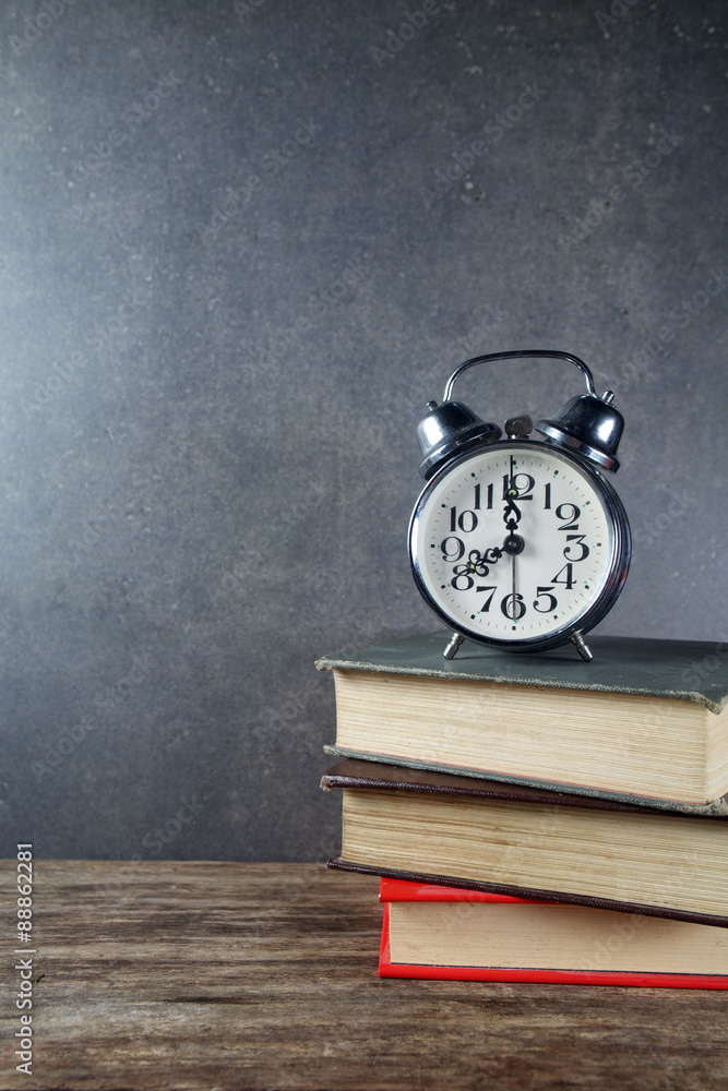 Back to school background with books and alarm clock Back to school background with books and alarm clock