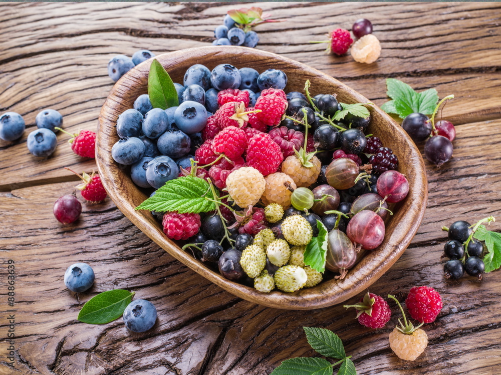 Ripe berries in the wooden bowl. Ripe berries in the wooden bowl.