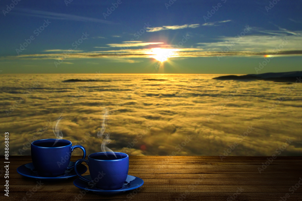 two cups with coffee against sunrise two cups with coffee against sunrise