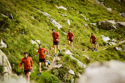 sequence of a man running on a mountain trail photo