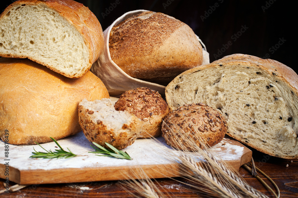 fresh bread and wheat on the wooden table fresh bread and wheat on the wooden table
