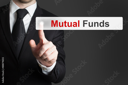 businessman pushing touchscreen button mutual funds