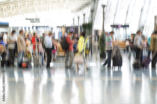 People silhouettes in motion blur, airport interior