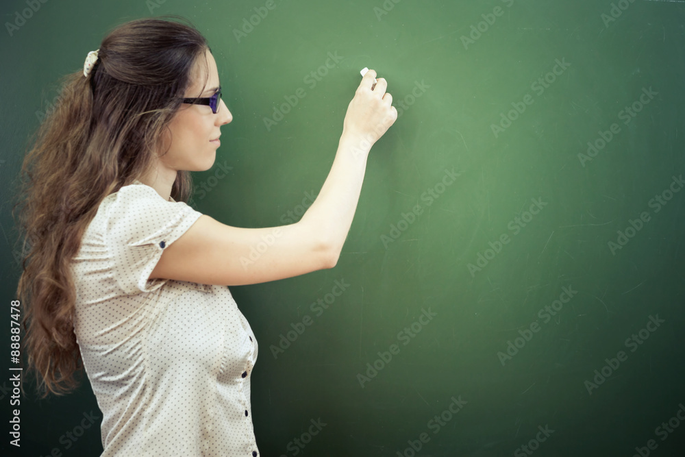 Teacher or student wrote on blackboard with chalk at classroom Teacher or student wrote on blackboard with chalk at classroom