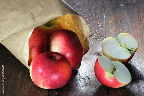 Äpfel der Sorte Elstar in Papiertüte auf Holzhintergrund photo