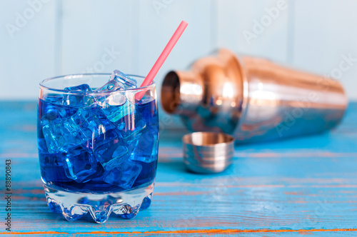 Cool refreshing blue curacao cocktail in pounchy glass with photo