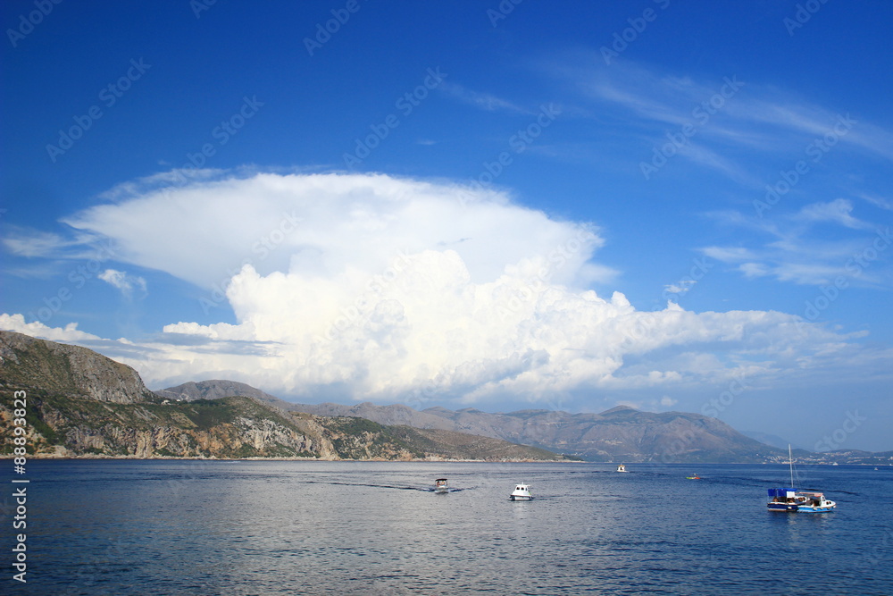 Big cumulonimbus and sea with the boats