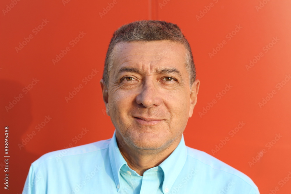 close up portrait of an elegant senior man brown eyed and with grey hair isolated on red background close up portrait of an elegant senior man brown eyed and with grey hair isolated on red background
