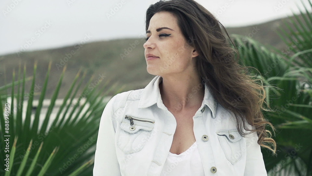 Thoughtful, young woman in garden enjoying windy day, slow motion shot at 240fpa
Thoughtful, young woman in garden enjoying windy day, slow motion shot at 240fpa