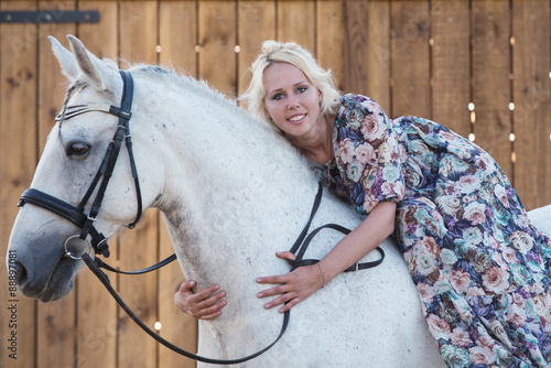 Beautiful blonde woman sitting on a horse