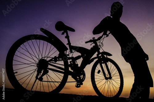 Silhouette of cyclist with twilight sky