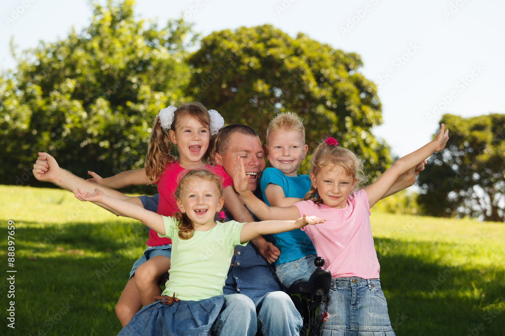 Disabled father with children having fun at the park Disabled father with children having fun at the park