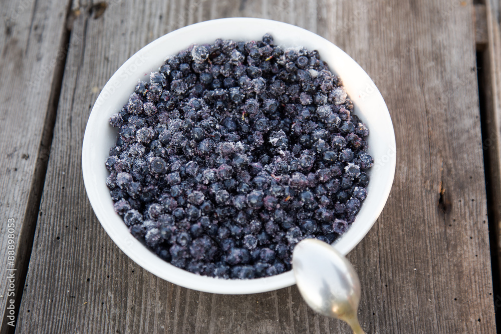 Full plate of blueberries on old wooden table Full plate of blueberries on old wooden table