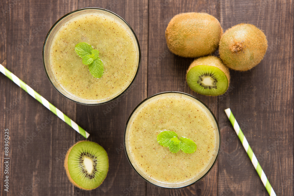 kiwi smoothie with fresh fruits on wooden background. Top view kiwi smoothie with fresh fruits on wooden background. Top view
