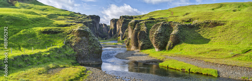 Fototapeta green hills of canyon with river and sky in Iceland