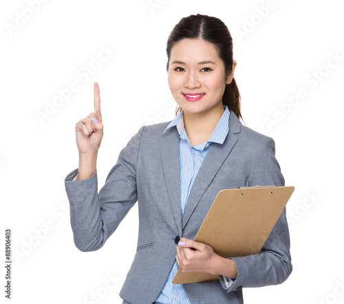 Asian young businesswoman carry with clipbaord and finger point photo