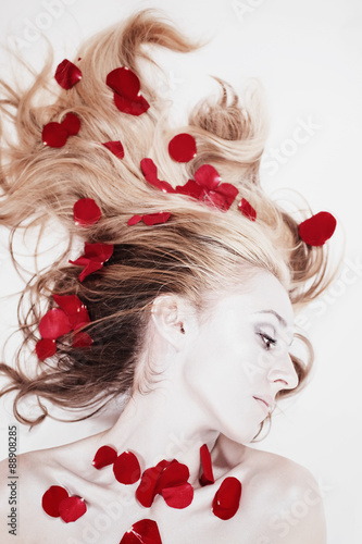 Woman with rose petals in her hair