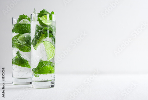 Mojito cocktail on the white wooden background