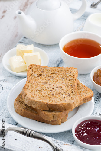 Breakfast with toast, jam and black tea, vertical