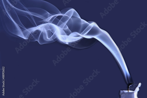 one extinguished candle in the smoke photo